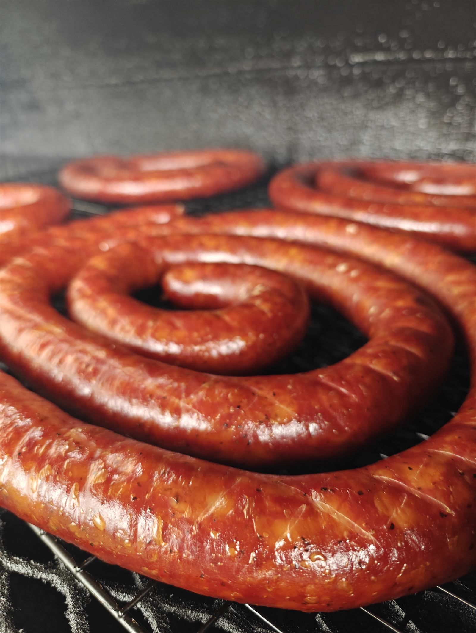 Coiled house-made Briar Ridge BBQ sausage fresh off the smoker