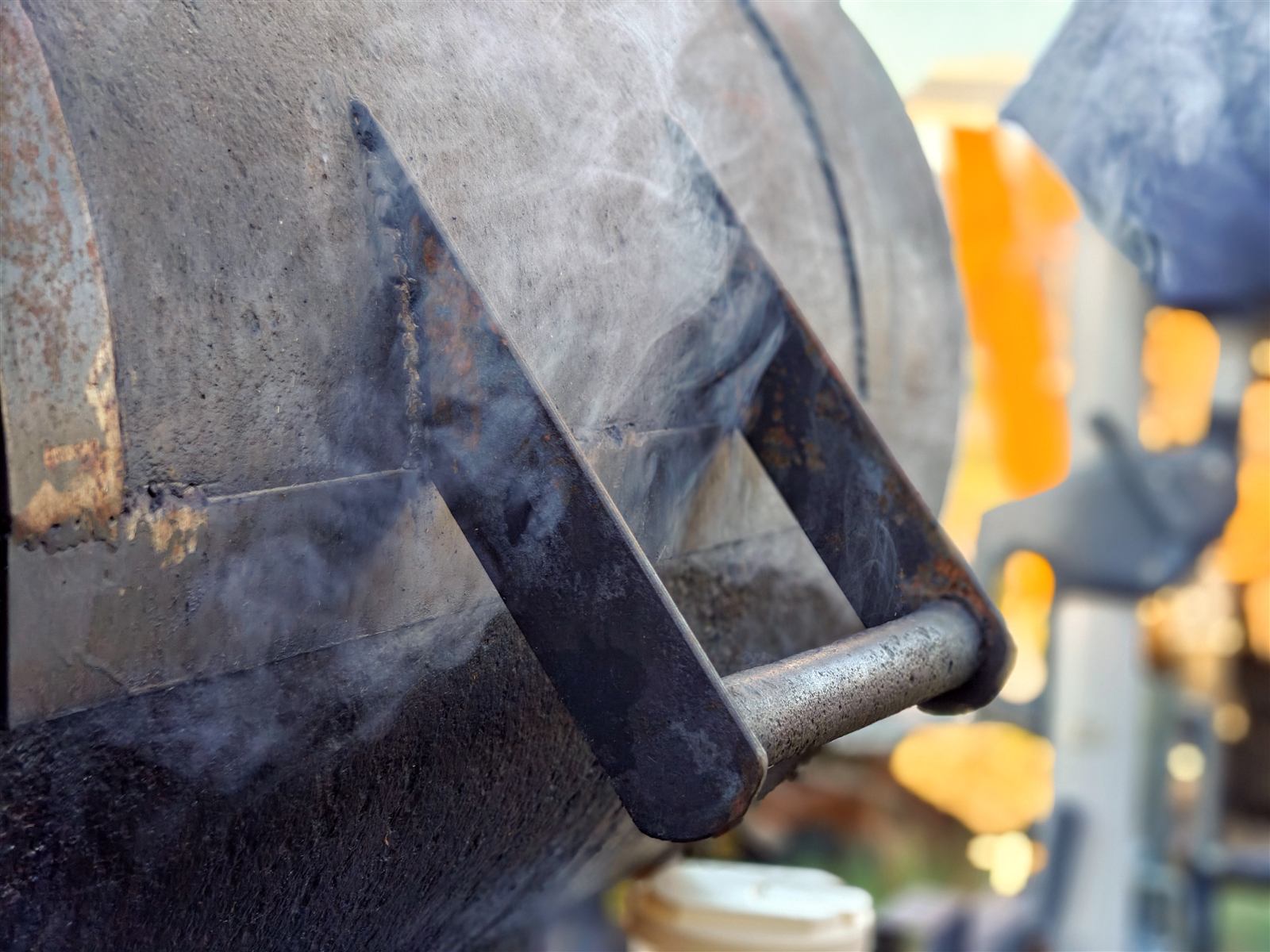 Detail of the smoker's welded steel and rising smoke